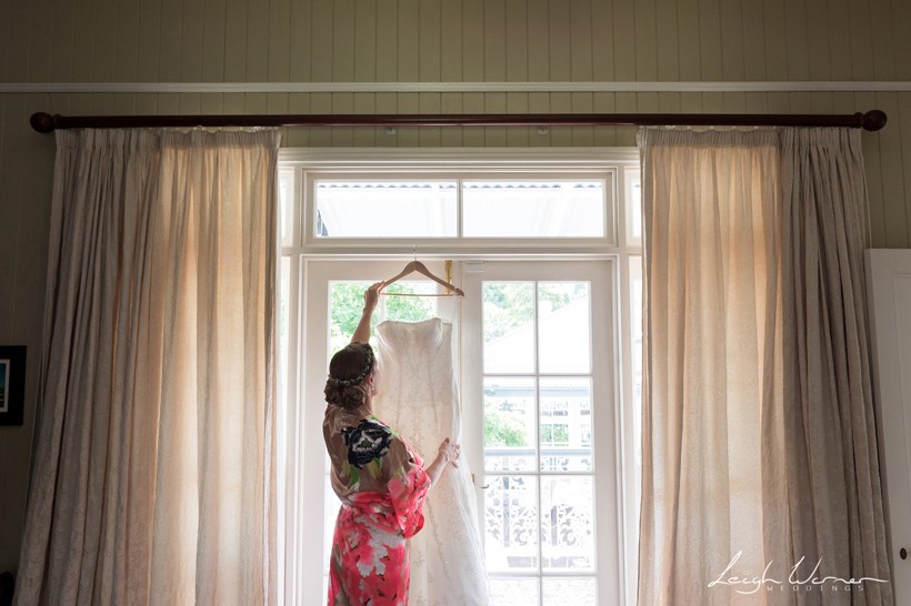 Bride and Wedding Dress in Window